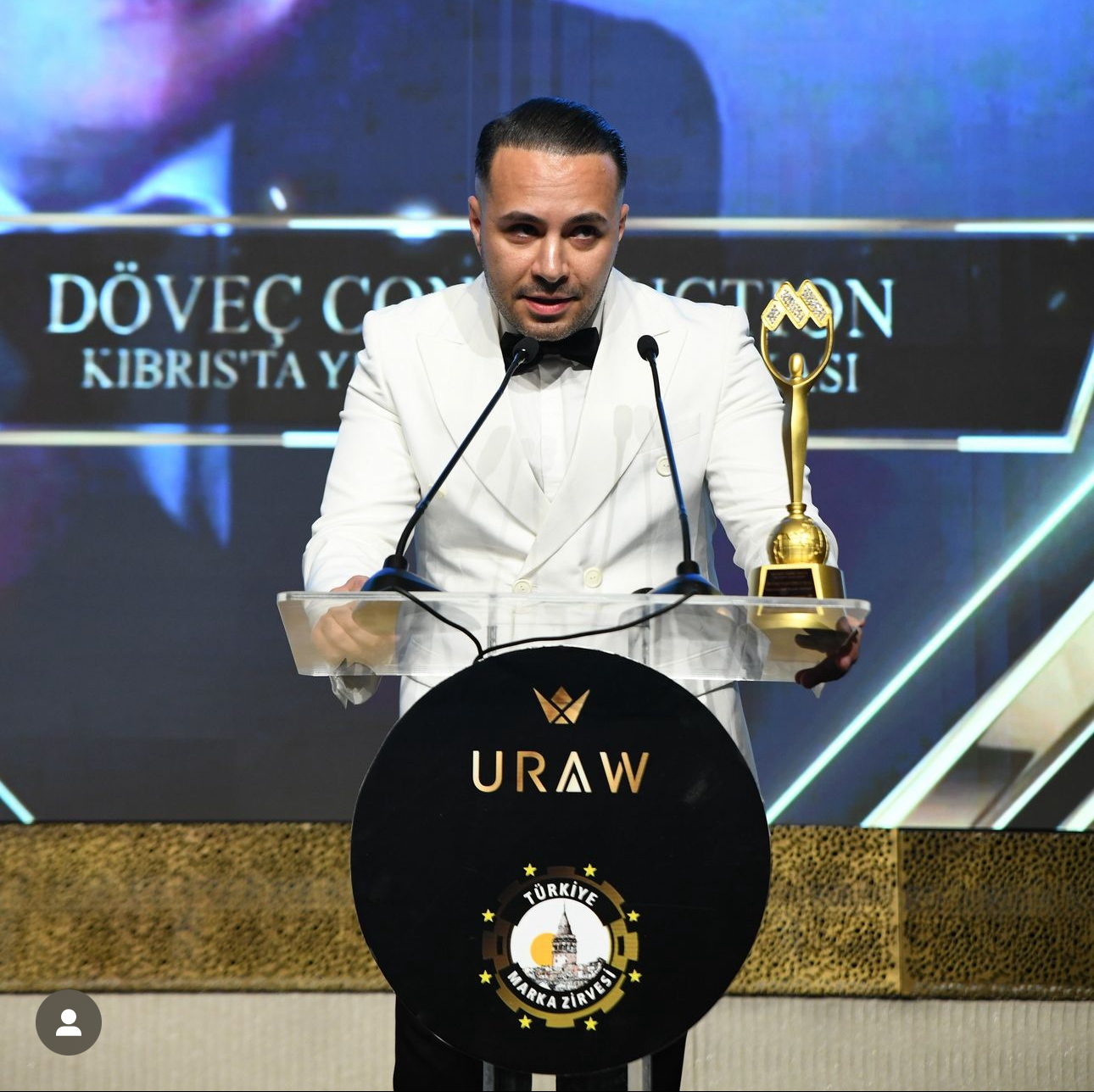 Kaveh Jafari accepting an award on stage at a brand summit