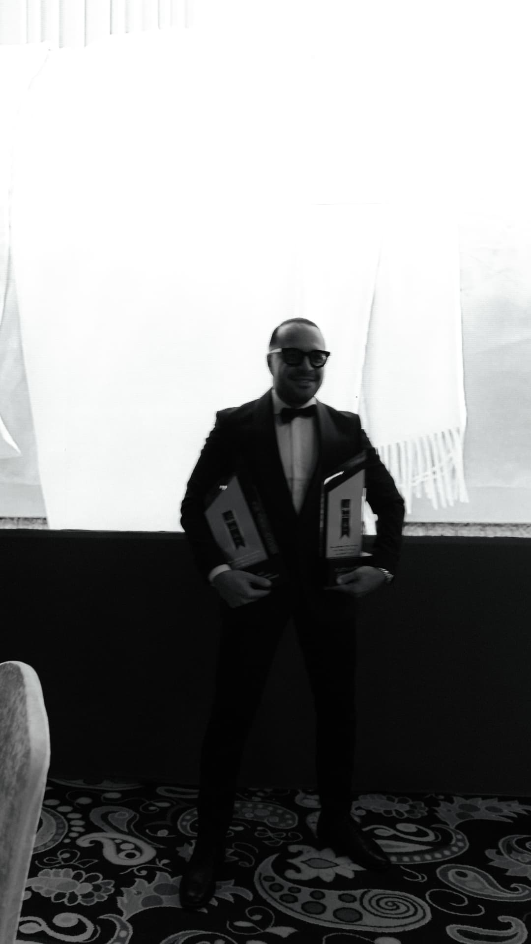 Kaveh Jafari holding two industry awards